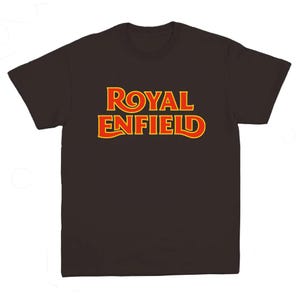 May include: A dark brown short-sleeved t-shirt featuring the text ROYAL ENFIELD printed in a bold, stylized font across the chest. The lettering is red with a bright yellow outline, creating a high-contrast graphic design on the solid fabric.