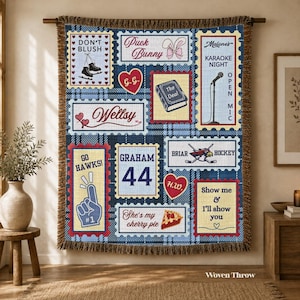 May include: A woven throw blanket featuring a blue and white plaid background with various rectangular patches. Designs include ice skates, a microphone, a hockey logo, the text "Puck Bunny," "Don't Blush," "Graham 44," and "Show me & I'll show you."