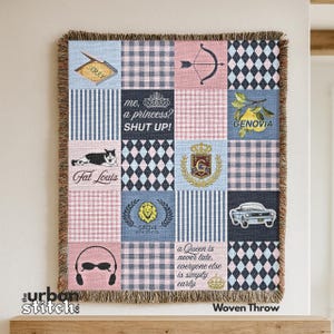 May include: Woven throw blanket with a patchwork design. The squares feature various patterns, including gingham, stripes, and diamonds, along with text and graphics such as a cat, a car, and the words "Sorry" and "Shut Up!"