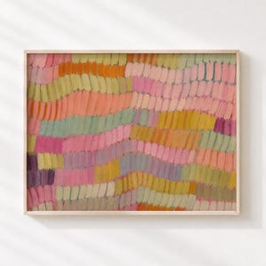 May include: A rectangular wall art print featuring a horizontal pattern of short, textured brushstrokes in shades of pink, orange, yellow, sage green, and lavender. The artwork is enclosed in a thin, light-colored wooden frame with a clean edge.