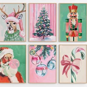 May include: Set of six framed Christmas-themed art prints. The prints feature a deer in a pink hat, a decorated Christmas tree, a nutcracker, Santa Claus blowing a bubble, ornaments, and a candy cane with a bow. The art has a watercolor style.