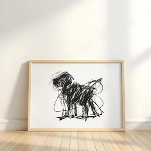 May include: A framed art print featuring a black abstract scribble drawing of a dog. The artwork is set against a white background, with a light wooden frame. The dog's form is created with bold, expressive lines.