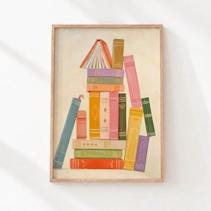 May include: A vertical art print featuring a stack of colourful books in various shades of orange, green, pink, yellow, and blue. The illustration depicts books arranged in a balanced pile with one open book at the top and others leaning against it.