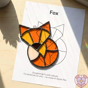 May include: A stained glass fox suncatcher with orange, yellow, and white segments. The fox is on a white paper with the word "Fox" and the text "Designed by FavorCutStudio. For personal use only - no resale of digital files."