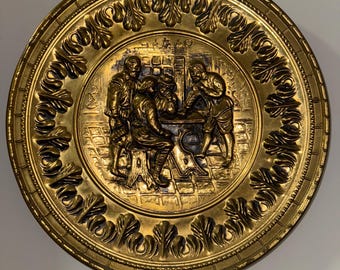 Vintage embossed brass wall plates featuring a tavern or pub
