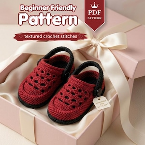 May include: A pair of handmade red and black crochet baby shoes with the text "Handmade for Little Feet" on a tag. The shoes are presented in a pink gift box with a white ribbon. The image also includes the text "Beginner Friendly Pattern" and "textured crochet stitches".