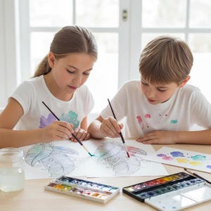 A lifestyle preview featuring two children painting intricate feather line art with watercolors. This 60-page collection is designed for all skill levels, offering high-quality bohemian feather designs that encourage artistic expression, fine motor skills, and creative mindfulness for both kids and adults. This printable activity is perfect for home-schooling, art therapy, and indoor family fun, providing a professional and engaging creative experience.