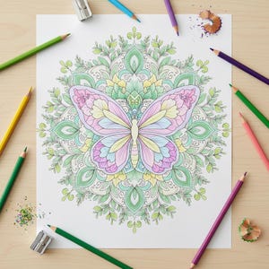 May include: A completed butterfly coloring page with a detailed mandala design. The butterfly is colored in pastel shades of pink, yellow, and blue. Colored pencils and sharpeners surround the page on a wooden surface.