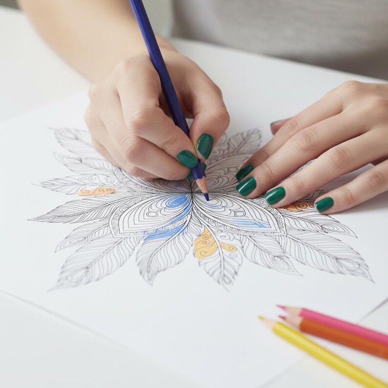 A lifestyle preview of a person's hands coloring a detailed feather mandala with a dark blue pencil. This 60-page collection features high-quality bohemian line art designed for adult relaxation, showcasing delicate feather patterns with light blue and golden yellow accents. This mindful creative activity is perfect for meditation, Zen-inspired art projects, and high-quality printable stress relief.