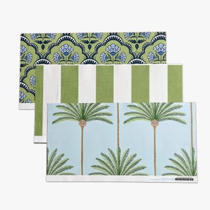 May include: Three decorative rectangular placemats with different patterns. One features a green and white striped design, another has a blue and white floral pattern on a green background, and the third has a light blue background with palm trees.