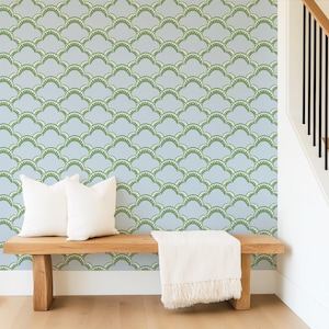 May include: Wallpaper featuring a repeating scalloped pattern in sage green and white on a light blue background. The design consists of overlapping arched shapes with a small, detailed fringe-like texture along the inner edge of each curve.