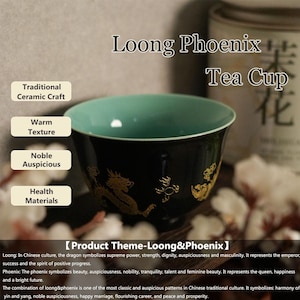 May include: Black ceramic tea cup with a teal interior and gold dragon and phoenix design. The text "Loong Phoenix Tea Cup" is displayed above the cup. The cup is labeled "Traditional Ceramic Craft" and "Health Materials".
