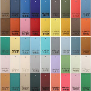 May include: A color swatch chart featuring a variety of hues, including blues, greens, reds, and yellows. Each swatch is rectangular with a small hole at the top, and includes text.