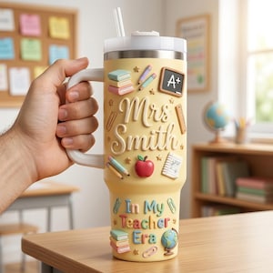 May include: A pale yellow insulated tumbler with a handle and straw, featuring raised 3D-style school-themed icons including books, pencils, an apple, a globe, and a chalkboard with A+. The text reads Mrs. Smith and In My Teacher Era.