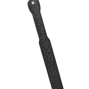 May include: A black leather paddle with a textured, swirling pattern. The paddle has a handle with a small hole at the top. The paddle is designed for impact play.