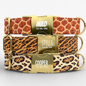 May include: Three personalized dog collars with gold-colored buckles. The top collar has a giraffe print, the middle one a leopard print, and the bottom one a cheetah print. Each buckle displays a name and phone number: MILO, STELLA, and COOPER.
