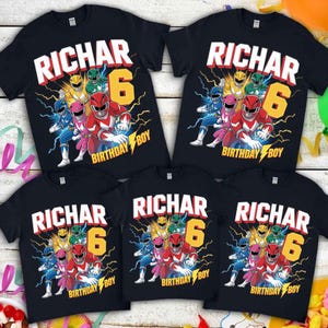 May include: Black t-shirts with a colorful graphic featuring Power Rangers, the name "RICHAR", the number "6", and the text "BIRTHDAY BOY". The design includes a lightning bolt.