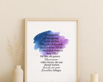 May include: A framed print with a light wood frame. The artwork features a watercolor design in blue and purple hues, with German text. The print is displayed on a neutral-toned surface, with a vase, books, and candles.
