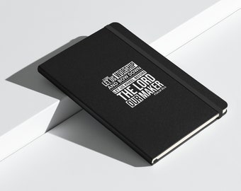 May include: A black notebook featuring the white text "LET US WORSHIP AND BOW DOWN LET US KNEEL BEFORE THE LORD OUR MAKER". It has a black elastic closure and a textured cover. The text "PSALM 95:5" is also visible.