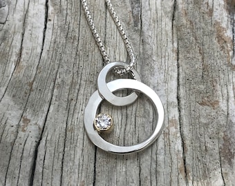 Floating circle lab grown diamond pendant. Sterling silver and 18kt gold. 18 inch chain.