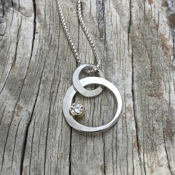 Floating circle lab grown diamond pendant. Sterling silver and 18kt gold. 18 inch chain.