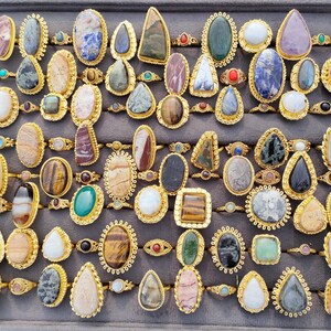 Assorted natural gemstone gold plated rings, wholesale gemstone ring lot, bulk boho rings for resale, handmade crystal rings collection, gold plated brass rings women, mixed stone ring assortment, boutique jewelry supplier rings, bohemian stacking rings set, minimalist gemstone rings bulk, adjustable gold rings wholesale, mothers day gift rings set, spiritual crystal jewelry lot, reseller jewelry bulk pack, artisan handmade ring mix, trendy boho gift jewelry
