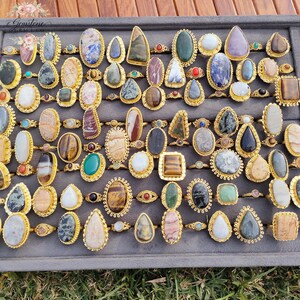Assorted natural gemstone gold plated rings, wholesale gemstone ring lot, bulk boho rings for resale, handmade crystal rings collection, gold plated brass rings women, mixed stone ring assortment, boutique jewelry supplier rings, bohemian stacking rings set, minimalist gemstone rings bulk, adjustable gold rings wholesale, mothers day gift rings set, spiritual crystal jewelry lot, reseller jewelry bulk pack, artisan handmade ring mix, trendy boho gift jewelry