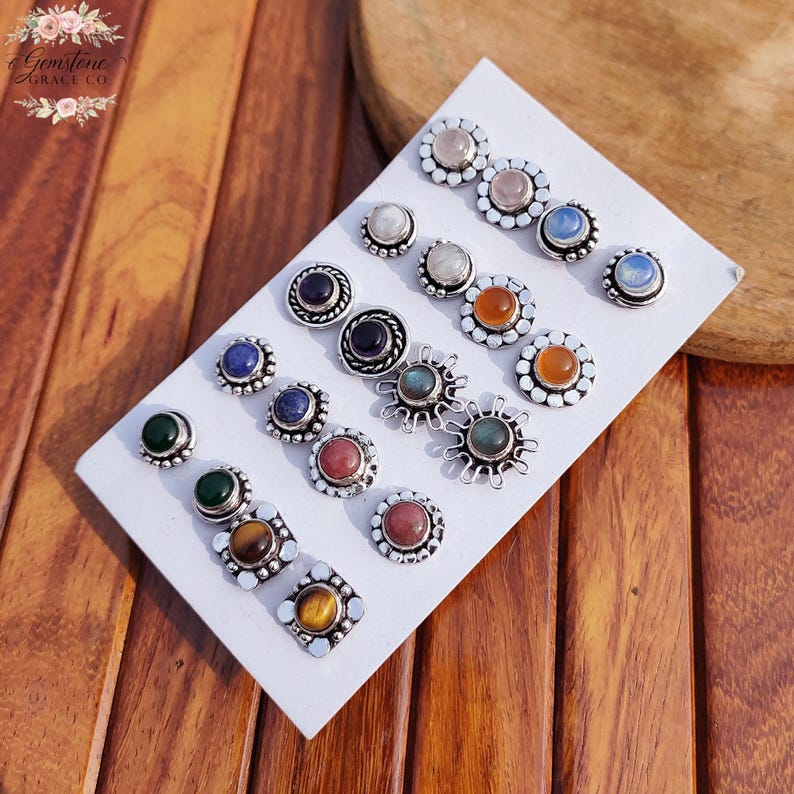 Wholesale mix gemstone stud earrings displayed on card, featuring assorted natural stones including moonstone, labradorite, amethyst, lapis lazuli, tiger eye, green onyx and carnelian. Handmade silver plated stud earrings with brass base metal, mixed designs and shapes. Bulk gemstone stud earrings for jewelry resellers, boutiques, birthstone collections, boho jewelry shops, crystal lovers and wholesale jewelry supply businesses.