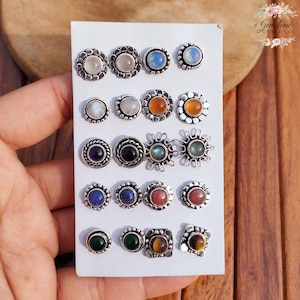 Wholesale mix gemstone stud earrings displayed on card, featuring assorted natural stones including moonstone, labradorite, amethyst, lapis lazuli, tiger eye, green onyx and carnelian. Handmade silver plated stud earrings with brass base metal, mixed designs and shapes. Bulk gemstone stud earrings for jewelry resellers, boutiques, birthstone collections, boho jewelry shops, crystal lovers and wholesale jewelry supply businesses.