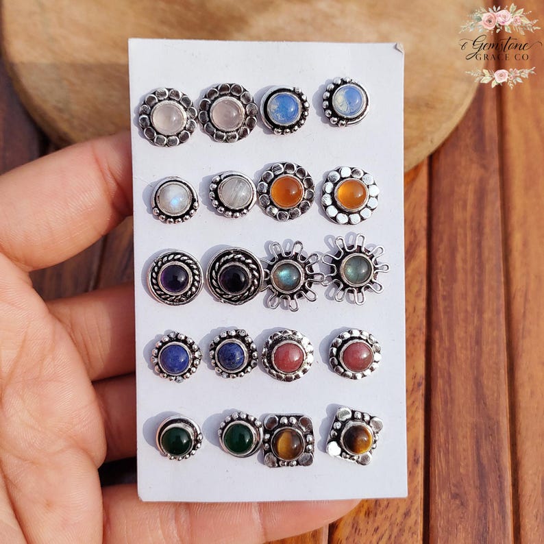 Wholesale mix gemstone stud earrings displayed on card, featuring assorted natural stones including moonstone, labradorite, amethyst, lapis lazuli, tiger eye, green onyx and carnelian. Handmade silver plated stud earrings with brass base metal, mixed designs and shapes. Bulk gemstone stud earrings for jewelry resellers, boutiques, birthstone collections, boho jewelry shops, crystal lovers and wholesale jewelry supply businesses.