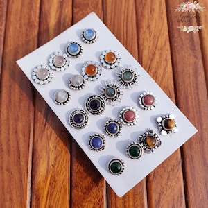 Wholesale mix gemstone stud earrings displayed on card, featuring assorted natural stones including moonstone, labradorite, amethyst, lapis lazuli, tiger eye, green onyx and carnelian. Handmade silver plated stud earrings with brass base metal, mixed designs and shapes. Bulk gemstone stud earrings for jewelry resellers, boutiques, birthstone collections, boho jewelry shops, crystal lovers and wholesale jewelry supply businesses.