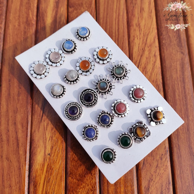 Wholesale mix gemstone stud earrings displayed on card, featuring assorted natural stones including moonstone, labradorite, amethyst, lapis lazuli, tiger eye, green onyx and carnelian. Handmade silver plated stud earrings with brass base metal, mixed designs and shapes. Bulk gemstone stud earrings for jewelry resellers, boutiques, birthstone collections, boho jewelry shops, crystal lovers and wholesale jewelry supply businesses.