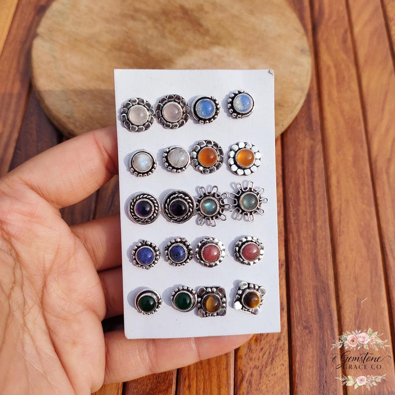 Wholesale mix gemstone stud earrings displayed on card, featuring assorted natural stones including moonstone, labradorite, amethyst, lapis lazuli, tiger eye, green onyx and carnelian. Handmade silver plated stud earrings with brass base metal, mixed designs and shapes. Bulk gemstone stud earrings for jewelry resellers, boutiques, birthstone collections, boho jewelry shops, crystal lovers and wholesale jewelry supply businesses.