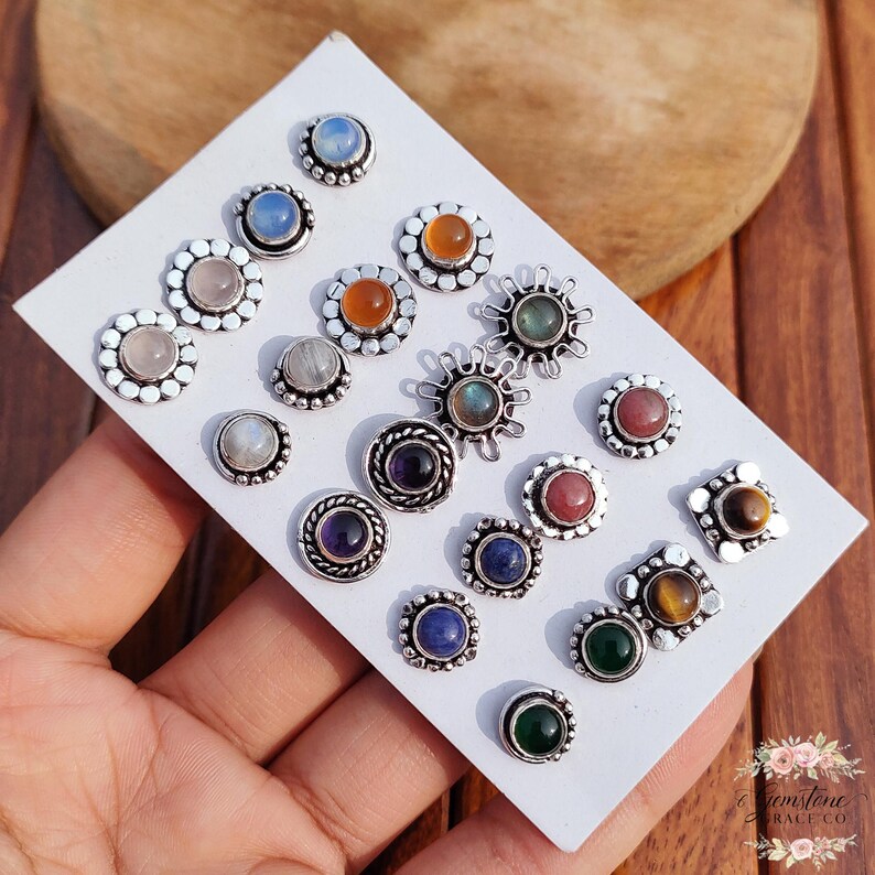 Wholesale mix gemstone stud earrings displayed on card, featuring assorted natural stones including moonstone, labradorite, amethyst, lapis lazuli, tiger eye, green onyx and carnelian. Handmade silver plated stud earrings with brass base metal, mixed designs and shapes. Bulk gemstone stud earrings for jewelry resellers, boutiques, birthstone collections, boho jewelry shops, crystal lovers and wholesale jewelry supply businesses.