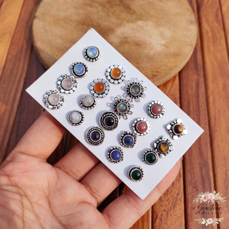 Wholesale mix gemstone stud earrings displayed on card, featuring assorted natural stones including moonstone, labradorite, amethyst, lapis lazuli, tiger eye, green onyx and carnelian. Handmade silver plated stud earrings with brass base metal, mixed designs and shapes. Bulk gemstone stud earrings for jewelry resellers, boutiques, birthstone collections, boho jewelry shops, crystal lovers and wholesale jewelry supply businesses.