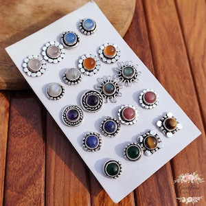 Wholesale mix gemstone stud earrings displayed on card, featuring assorted natural stones including moonstone, labradorite, amethyst, lapis lazuli, tiger eye, green onyx and carnelian. Handmade silver plated stud earrings with brass base metal, mixed designs and shapes. Bulk gemstone stud earrings for jewelry resellers, boutiques, birthstone collections, boho jewelry shops, crystal lovers and wholesale jewelry supply businesses.