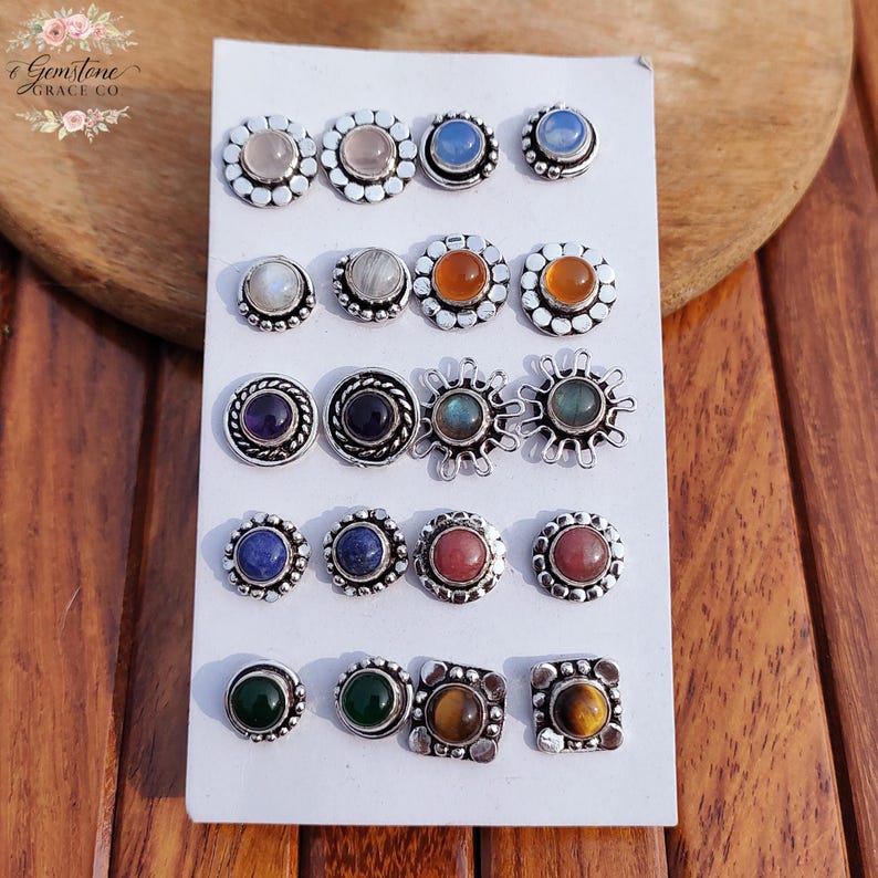 Wholesale mix gemstone stud earrings displayed on card, featuring assorted natural stones including moonstone, labradorite, amethyst, lapis lazuli, tiger eye, green onyx and carnelian. Handmade silver plated stud earrings with brass base metal, mixed designs and shapes. Bulk gemstone stud earrings for jewelry resellers, boutiques, birthstone collections, boho jewelry shops, crystal lovers and wholesale jewelry supply businesses.