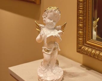 Angel statue. A pensive cherub figurine. Aesthetic home decor. Angel figurine
