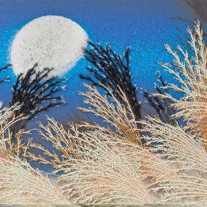 May include: A beaded artwork depicting a full moon in a blue sky, with detailed, textured white and gold-toned grasses in the foreground. Black branches are interspersed among the grasses, creating a contrast against the moon and sky.