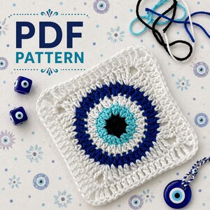 May include: A white crochet square with a blue and turquoise eye design, with the text "PDF PATTERN". Two blue dice with eye symbols and a blue eye charm are also present. Blue, black, and white yarn are in the background.