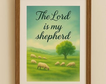 May include: A framed print featuring a pastoral scene with sheep grazing on a green hillside under a blue sky. The artwork includes the text "The Lord is my shepherd" in elegant script. The frame is a warm brown color.
