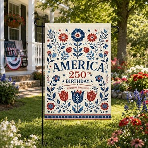May include: A cream-colored garden flag with a patriotic design. The flag features the words "AMERICA 250th BIRTHDAY" in navy blue, with red and blue floral and star accents. The text "RESISTING SINCE 1776" is also included.