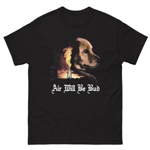 May include: Black t-shirt featuring a dog's profile with a fiery industrial scene. The text "Air Will Be Bud" is displayed in white, stylized font. The shirt is made of a soft material.