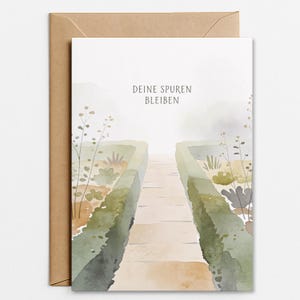 Op de afbeelding: Waterverf wenskaart met een tuinpad en de tekst "DEINE SPUREN BLEIBEN". De kaart wordt geleverd met een bruine envelop. Het kunstwerk gebruikt zachte groen-, bruin- en beigetinten.