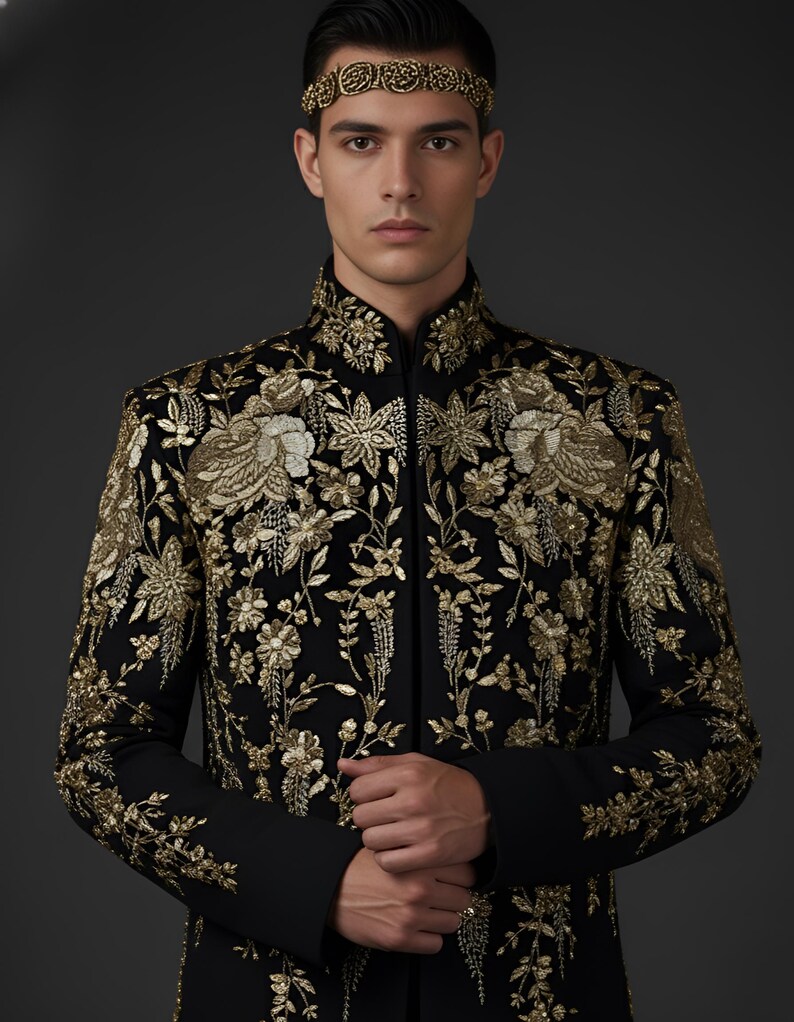 May include: A black jacket with intricate gold floral embroidery. The jacket features a mandarin collar and long sleeves. A gold headband complements the jacket's design. The garment is a formal wear item.