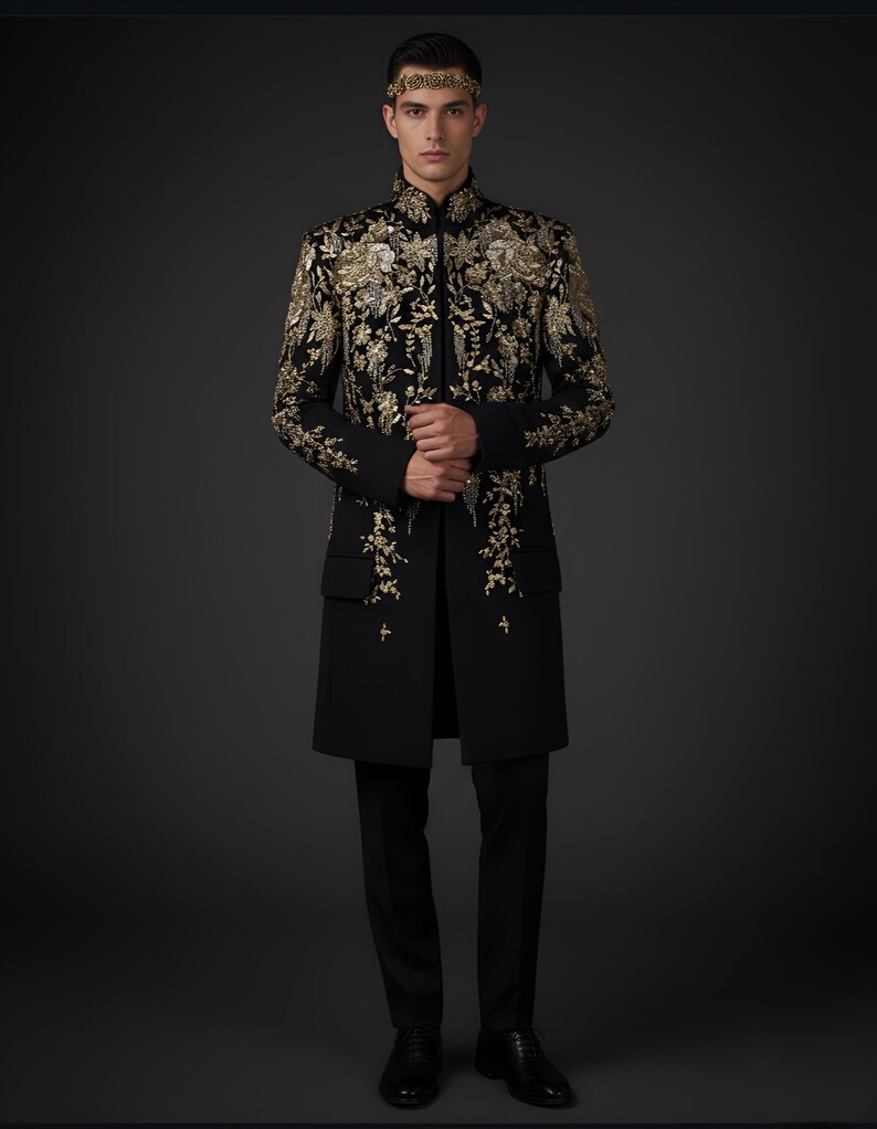 May include: A black, long coat with intricate gold embroidery, featuring a mandarin collar and a tailored fit. The coat is paired with black trousers and shoes. A gold headband completes the ensemble.