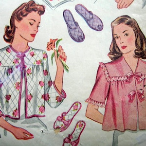 May include: Vintage illustration of women's sleepwear. One woman is wearing a white quilted jacket with pink rose accents and a matching bow. The other woman is wearing a pink top with a ruffled collar and bow details. Matching slippers are also shown.