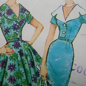 May include: Two vintage dress patterns, one with a floral print and the other with a solid blue color. Both dresses have a collared neckline and short sleeves.