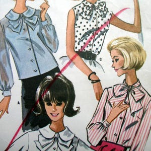 May include: Vintage sewing pattern featuring illustrations of blouses with bow details. The blouses are shown in various styles, including solid, polka dot, and striped patterns. The color palette includes blue, white, and pink.