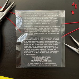 May include: Red string of fate bracelet with a white background and text explaining the legend of the red string of fate. The text includes the website and social media handles for Weareallsmith.